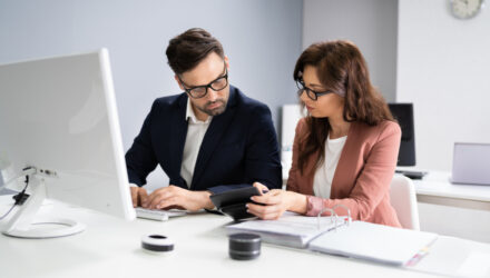 man and woman sitting at a computer