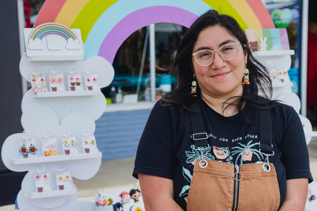 Latina woman standing in front of her small business shop